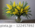 Bouquet of mimosa flowers in a vase on blue background, spring background 122457892