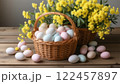Easter colorful eggs and a basket of mimosa flowers, symbols of the Christian holiday 122457897