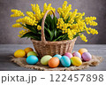 Easter colorful eggs and a basket of mimosa flowers, symbols of the Christian holiday 122457898