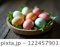 Easter Colorful Eggs In Plate On Leaves Greens On Wooden Table, Christian Religious Holiday 122457901