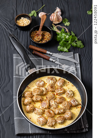 Ground poultry meatballs in a white cream gravy 122458091