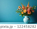 Bouquet of pink flowers in ceramic vase on blue background with copy space 122458282