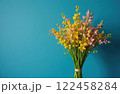 Bouquet of pink and yellow flowers on blue background with copy space 122458284