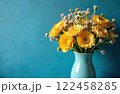 Bouquet of yellow flowers in ceramic vase on blue background with copy space 122458285