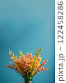 Bouquet of pink and yellow flowers on blue background with copy space 122458286