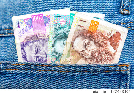 Czech crown banknotes sticking out of the pocket of jeans 122458304