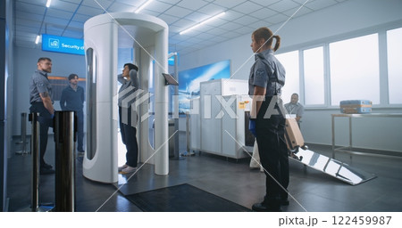 Airport Security Check: Diverse Passengers Passing Through Metal Detector Scanner Airport Security Check: Diverse Passengers Passing Through Metal Detector Scanner 122459987
