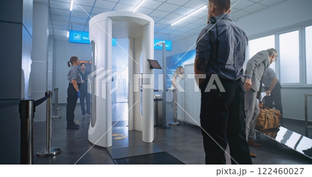 Airport Terminal Checkpoint: Diverse People Walking Through Metal Detector Gates Airport Terminal Checkpoint: Diverse People Walking Through Metal Detector Gates 122460027