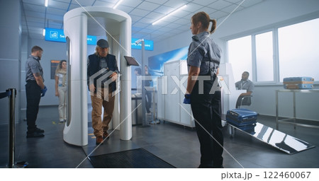 Airport Terminal Checkpoint: Diverse People Walking Through Metal Detector Gates Airport Terminal Checkpoint: Diverse People Walking Through Metal Detector Gates 122460067