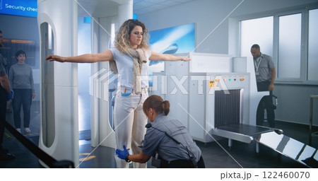 Female Security Officer Inspects Passenger, Documents, Ticket for Plane Flight Female Security Officer Inspects Passenger, Documents, Ticket for Plane Flight 122460070