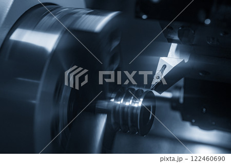 The  CNC lathe machine forming  cutting the metal shaft parts in the light blue scene. 122460690