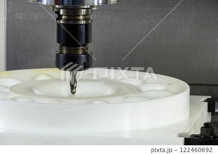 The CNC milling machine cutting the nylon parts with solid ball nose end mill tool. The CNC milling machine cutting the nylon parts with solid ball nose end mill tool. 122460692