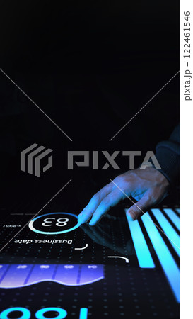 Marketer in dark clothing touching interactive digital screen with glowing blue analytics, bar charts, and circular data interface against dark background. Marketer in dark clothing touching interactive digital screen with glowing blue analytics, bar charts, and circular data interface against dark background. 122461546