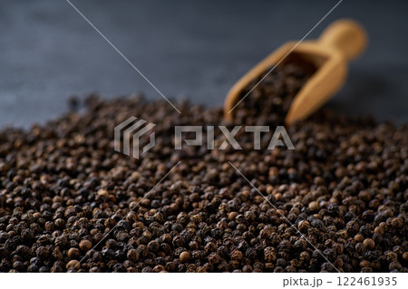 black pepper seeds on a black stone table, selective focus. 122461935