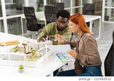 Two young architects working together on a new sustainable project Two young architects working together on a new sustainable project 122462012