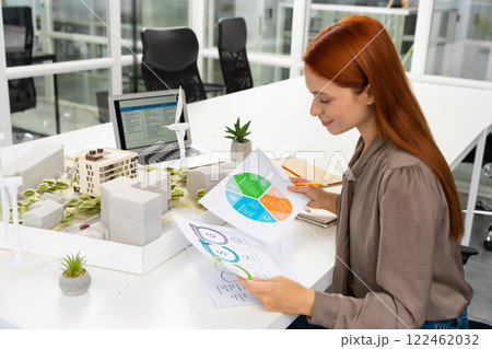 Female young architect working on a new sustainable construction project Female young architect working on a new sustainable construction project 122462032