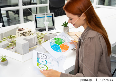 Female young architect working on a new sustainable construction project 122462033