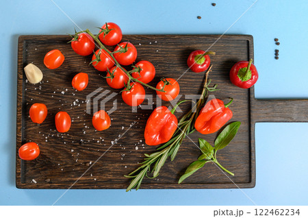 Fresh Tomatoes, Peppers, and Herbs on Wooden Board Fresh Tomatoes, Peppers, and Herbs on Wooden Board 122462234