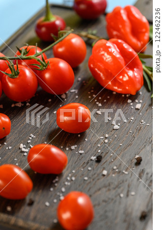 Fresh Tomatoes, Peppers, and Herbs on Wooden Board 122462236