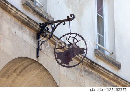 Old rusty wrought iron sign depicting a deer head 122462372