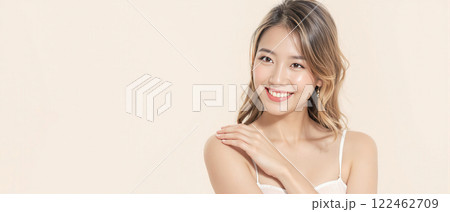 Smiling young woman with flawless skin posing against a pastel background, promoting beauty, skincare, and confidence. Smiling young woman with flawless skin posing against a pastel background, promoting beauty, skincare, and confidence. 122462709