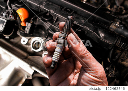 Car spark plug , close up of car spark plug in mechanic hand Car spark plug , close up of car spark plug in mechanic hand 122462846