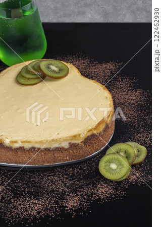Delicious cheesecake with cottage cheese on the table, decorated with kiwi. 122462930