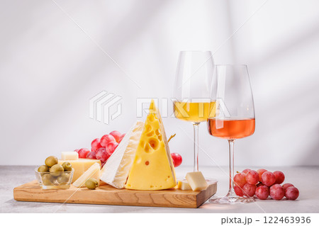 A delectable arrangement of various cheeses, fresh grapes, and wine A delectable arrangement of various cheeses, fresh grapes, and wine 122463936