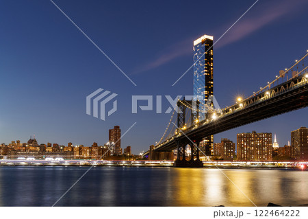 A panoramic sunset view of the Manhattan Bridge stretching towards Manhattan A panoramic sunset view of the Manhattan Bridge stretching towards Manhattan 122464222