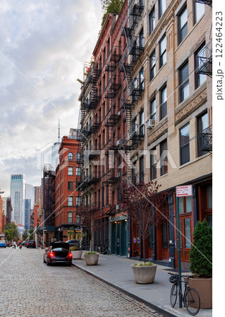 Captivating view of a bustling NYC Downtown street framed by iconic Manhattan skyscrapers 122464223