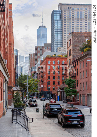 Captivating view of a bustling NYC Downtown street framed by iconic Manhattan skyscrapers Captivating view of a bustling NYC Downtown street framed by iconic Manhattan skyscrapers 122464224