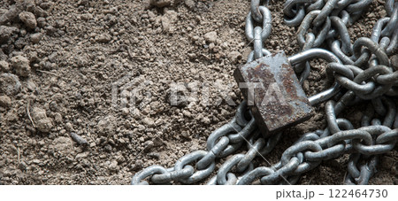 An old metal chain lies on the ground An old metal chain lies on the ground 122464730