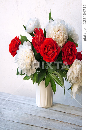 Bouquet of peonies and roses on a table 122464736