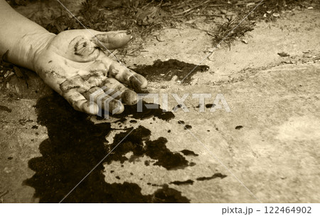 A man's hand in blood lies on the ground A man's hand in blood lies on the ground 122464902