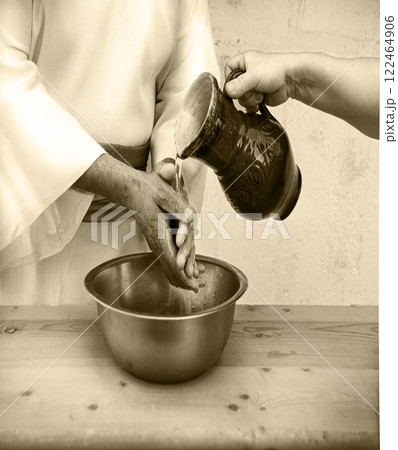 The servant pours water, and the master washes his hands 122464906