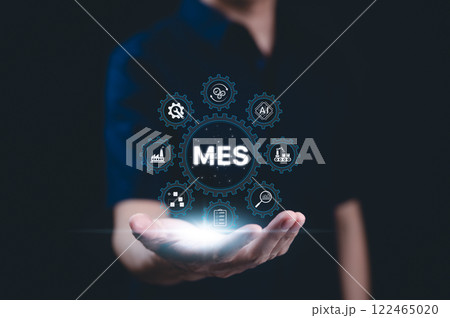 MES - Manufacturing Execution System Concept. A person presents a glowing MES icon with digital symbols related to manufacturing, automation, industrial processes, technology in production management, MES - Manufacturing Execution System Concept. A person presents a glowing MES icon with digital symbols related to manufacturing, automation, industrial processes, technology in production management, 122465020