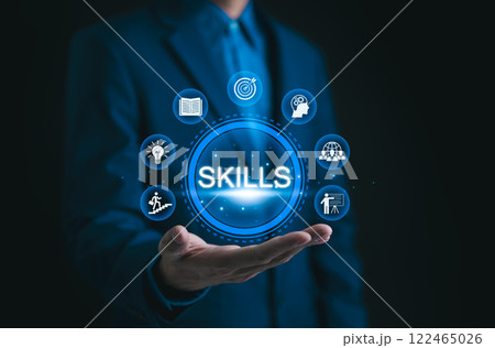 Skills Development Concept. Businessman presenting digital representation of essential skills, including knowledge, goal-setting, creativity, and leadership. personal growth and development. Learning 122465026
