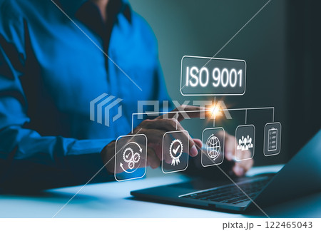 ISO 9001 certification and quality management concept. Businessman interact with virtual ISO 9001 icons, representing quality management principles, standards, and compliance in business operations. 122465043