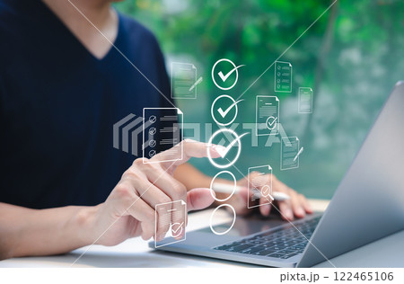 Online assessment and survey concept. A person interacts with virtual checklist on laptop, symbolizing online assessments, surveys, exams, or quizzes. digital evaluation and data collection. fill out, Online assessment and survey concept. A person interacts with virtual checklist on laptop, symbolizing online assessments, surveys, exams, or quizzes. digital evaluation and data collection. fill out, 122465106