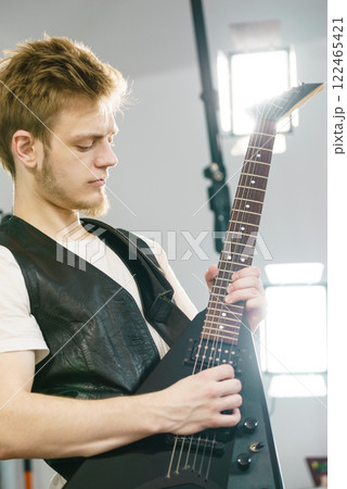 Man playing on electric guitar Man playing on electric guitar 122465421