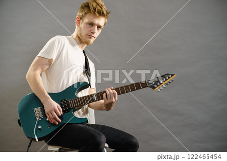 Man playing on electric guitar Man playing on electric guitar 122465454