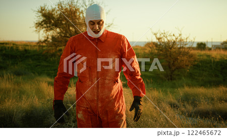 Male Astronaut In Orange Suit Shakes Toxic Contamination Dust From His Uniform 122465672