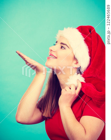 Happy woman wearing Santa Claus helper costume 122465689