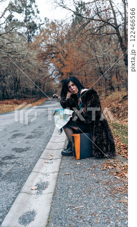 Woman with suitcase on the road 122466566