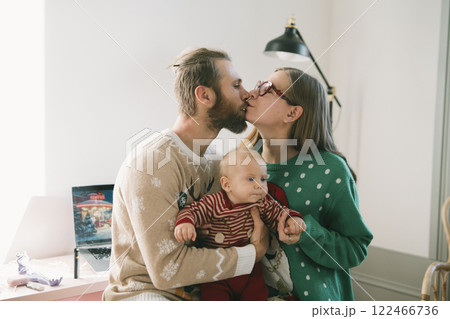 Experience the warmth and joy of family love through cozy holiday moments with your baby 122466736
