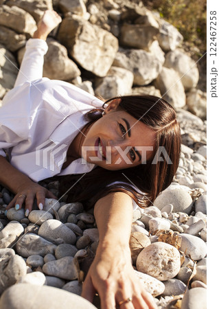 young pretty brunette woman on sea coast, lifestyle people concept young pretty brunette woman on sea coast, lifestyle people concept 122467258