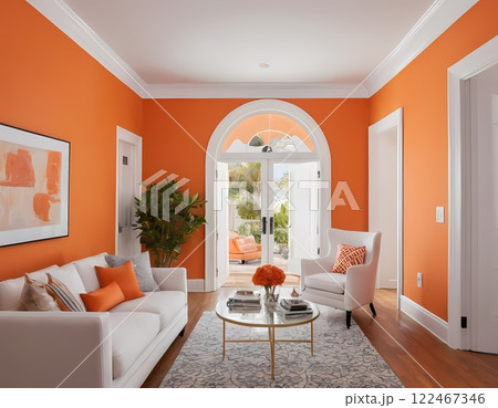 A living room sofa is positioned against an orange wall, with a white classic door in background A living room sofa is positioned against an orange wall, with a white classic door in background 122467346
