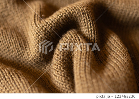 Mocha coloured knitted fabric with waves and selective blur. Mocha coloured knitted fabric with waves and selective blur. 122468230