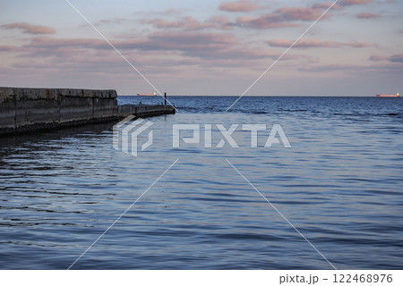 Odessa Bay of the Black Sea.  On a cloudy day, the Black Sea rolls in small waves onto the sandy beaches of Odessa. 122468976