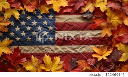 A red, white, and blue American flag is surrounded by a pile of orange leaves 122469143